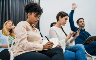 Group of young people sitting at conference together