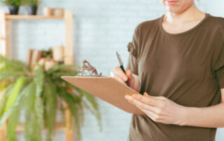 Woman holding a clipboard taking notes