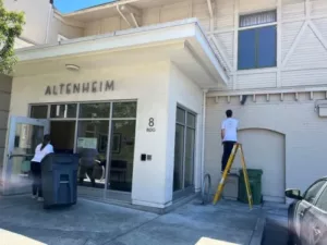 ESA CAM staff cleaning outside of Altenheim building