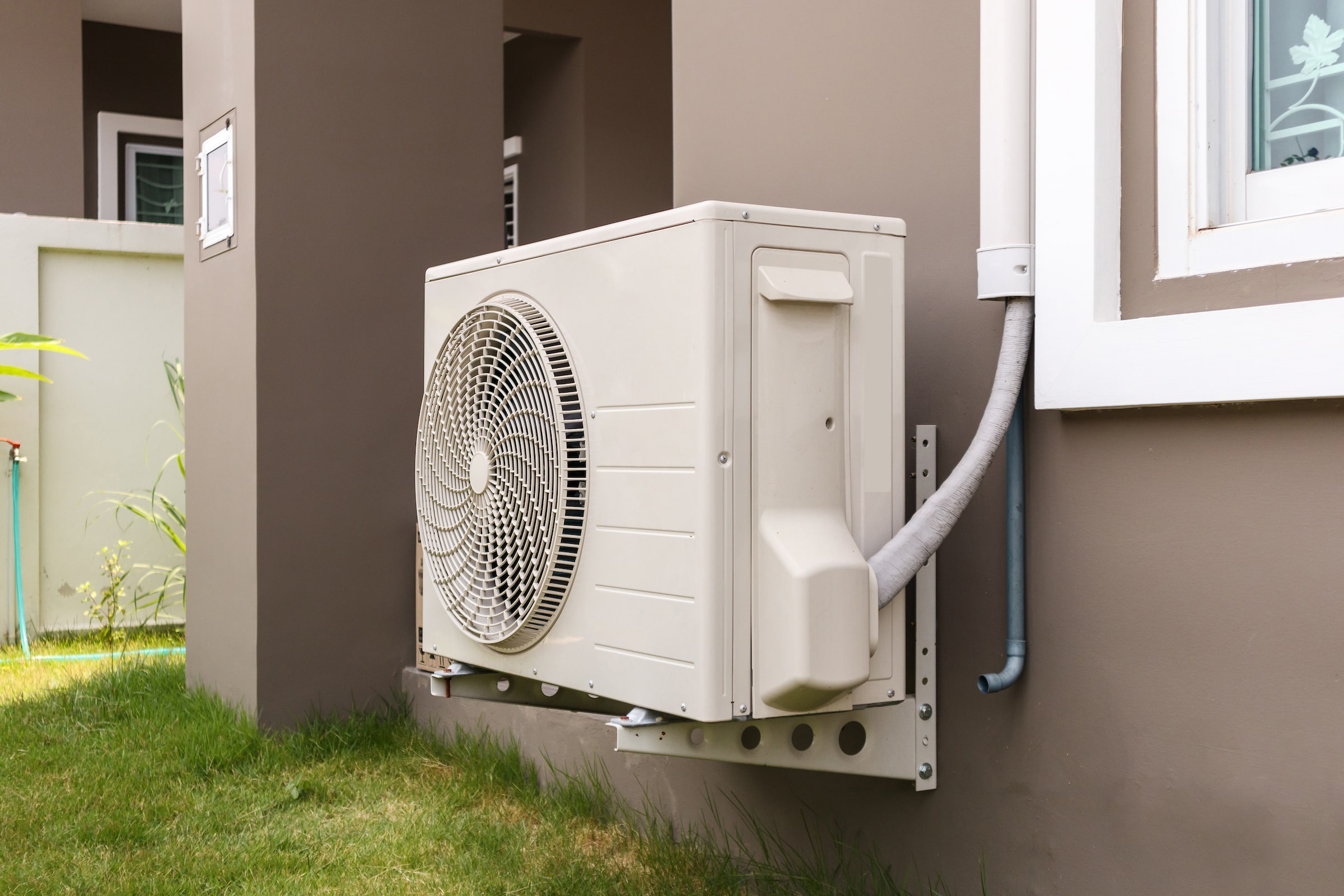 air-conditioner-compressor-outdoor-unit-installed-outside-house