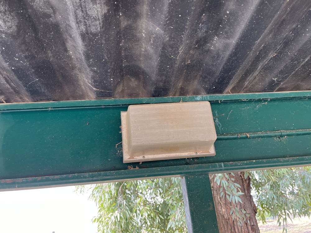 Before picture of LED Light fixture in parking lot of Huron Plaza Apartments